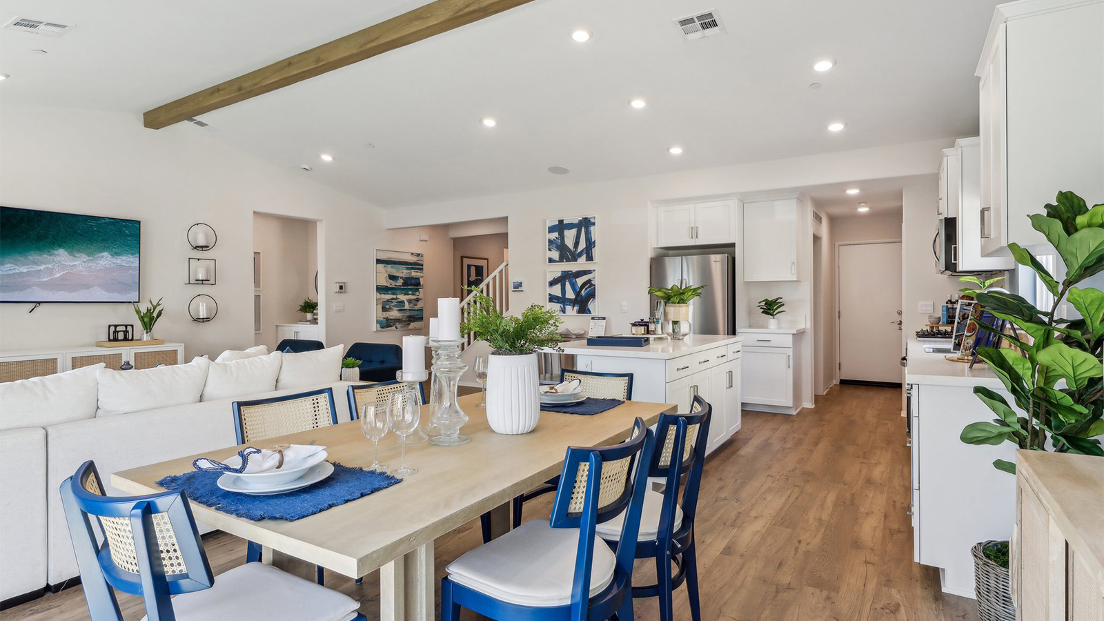 Spacious open-concept great room, dining room and kitchen with vaulted ceiling