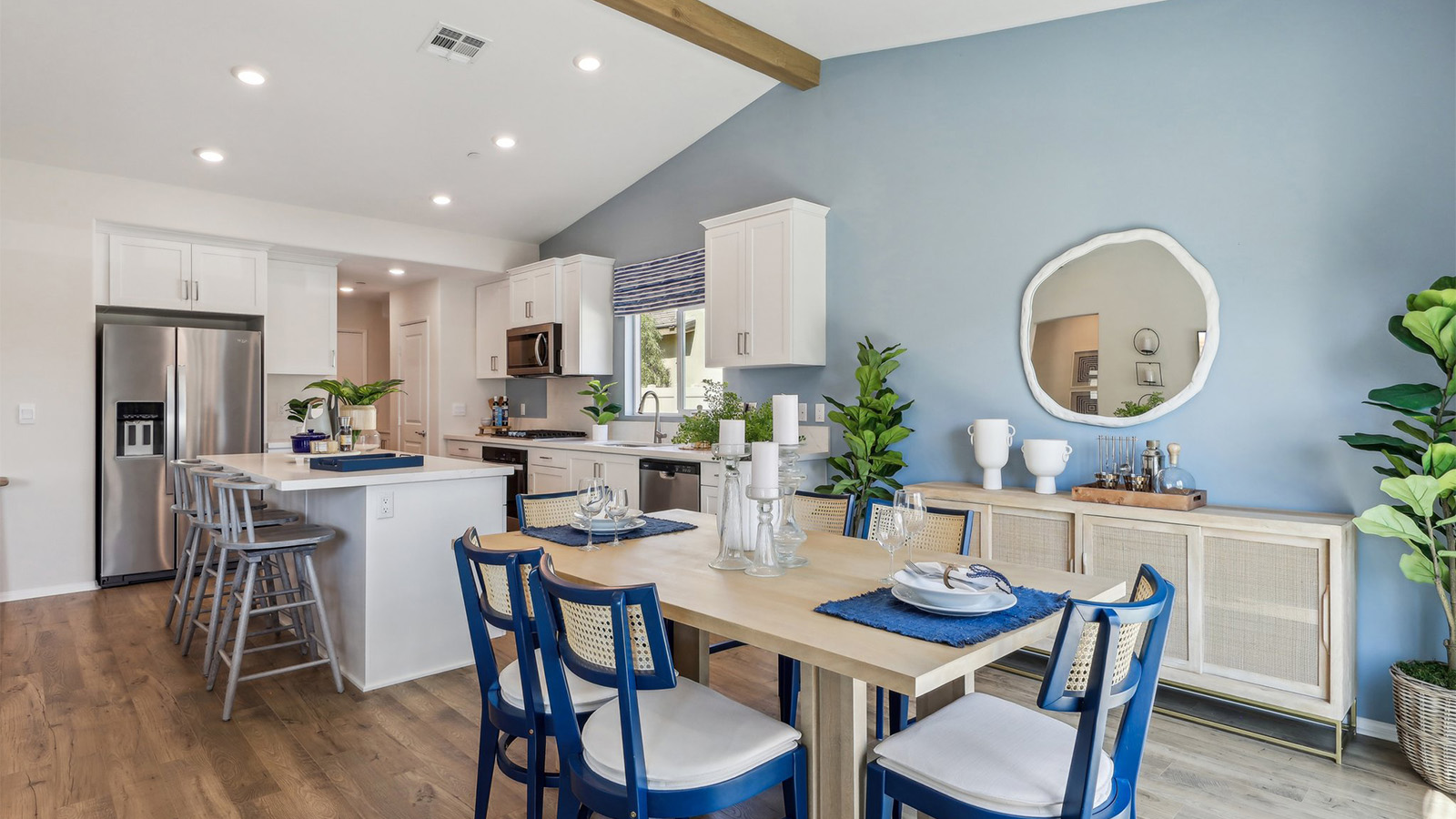 Spacious open-concept great room, dining room and kitchen with vaulted ceiling