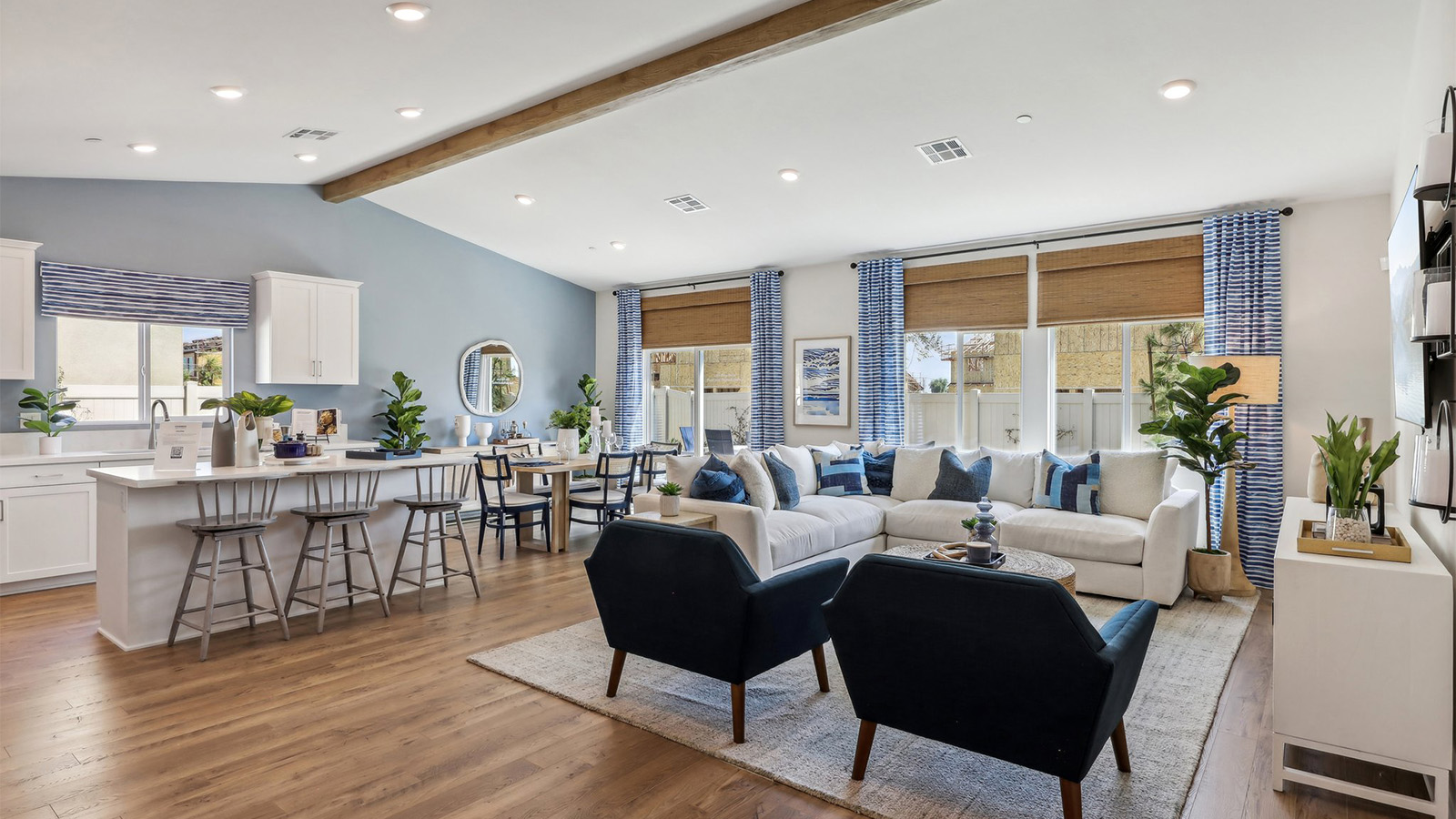 Spacious open-concept great room, dining room and kitchen with vaulted ceiling