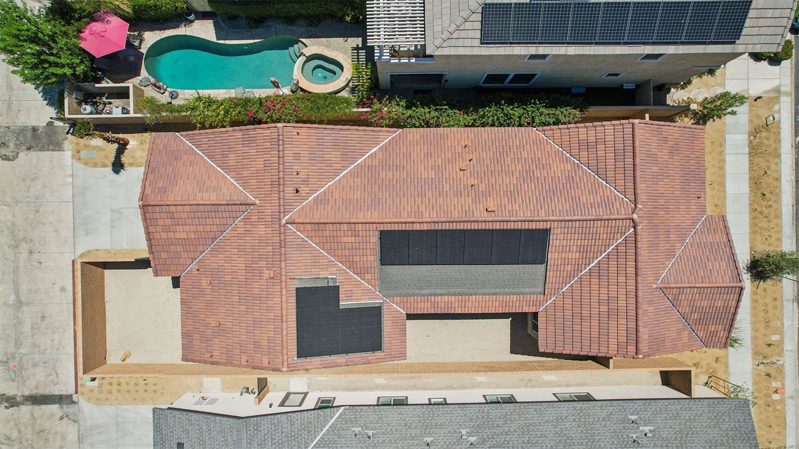 Aerial view of single family home with solar panels