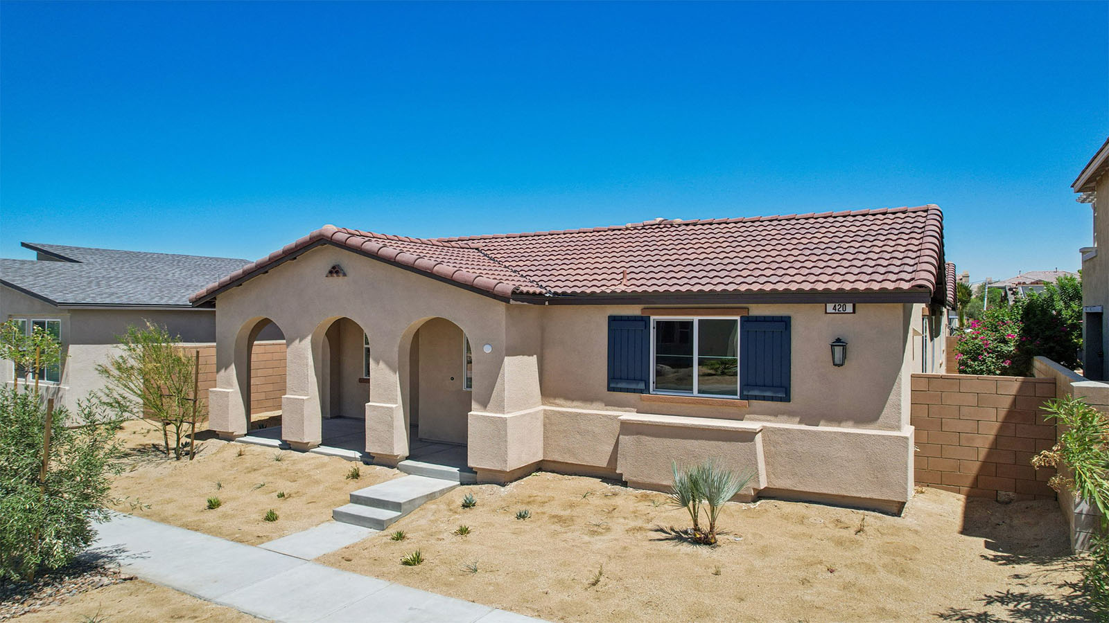 One-story Spanish home with shutters and two-car garage