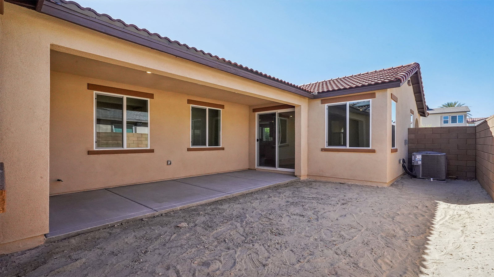 Rear yard of single story home with covered California room