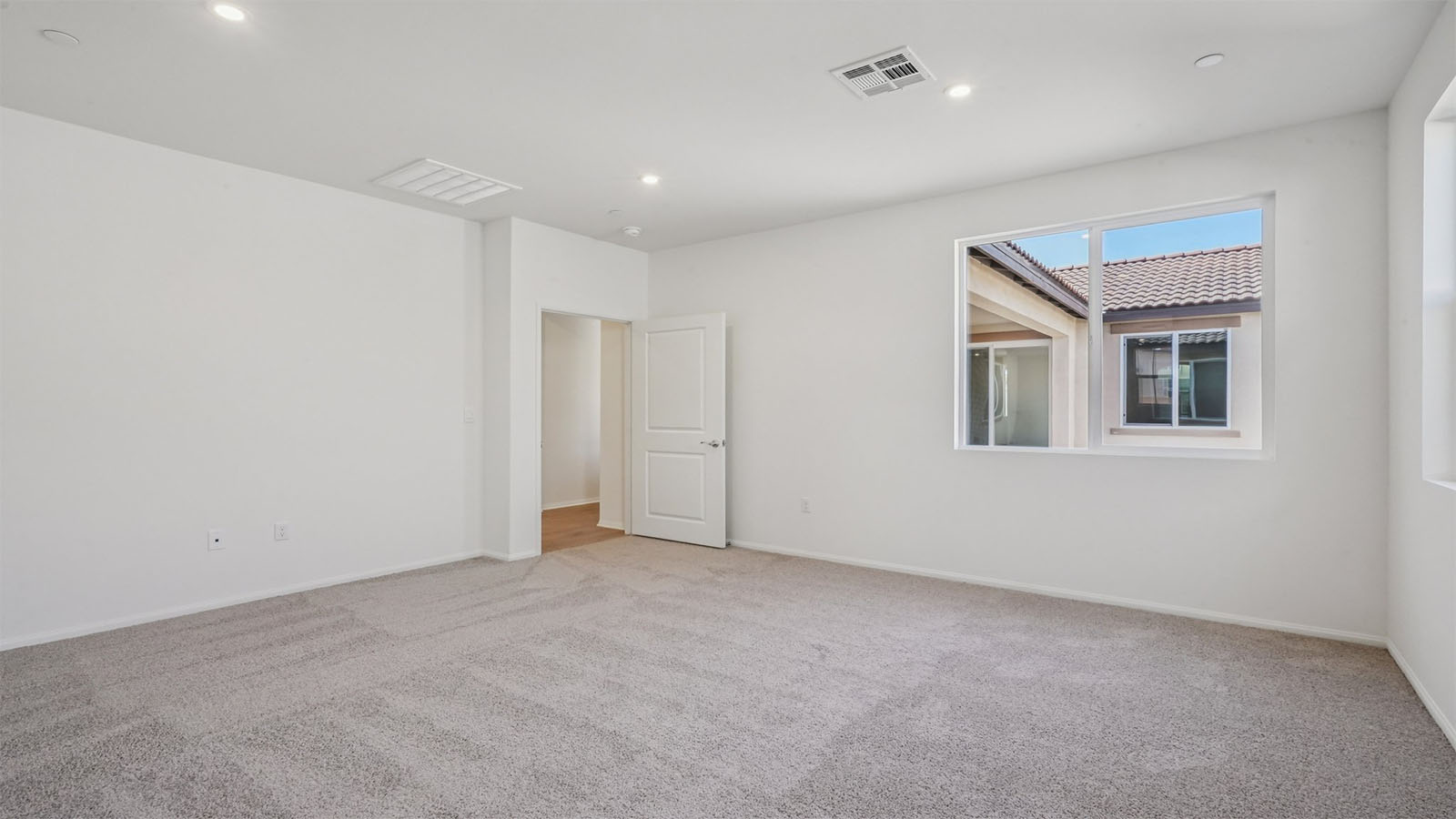 Primary bedroom with carpet