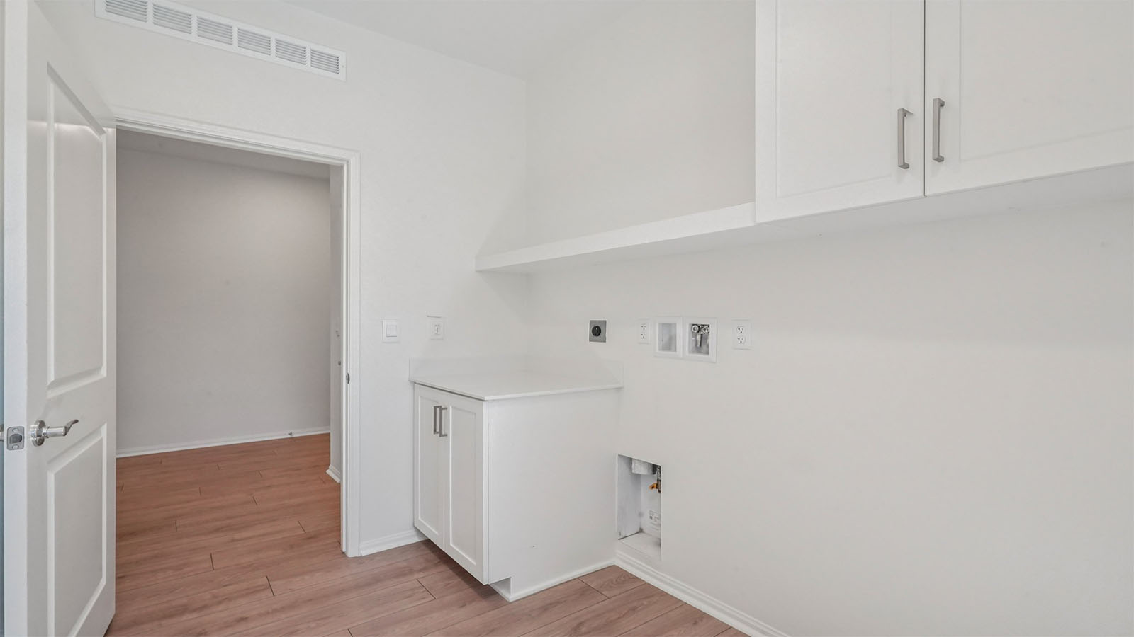 Laundry room with upper and lower cabinets