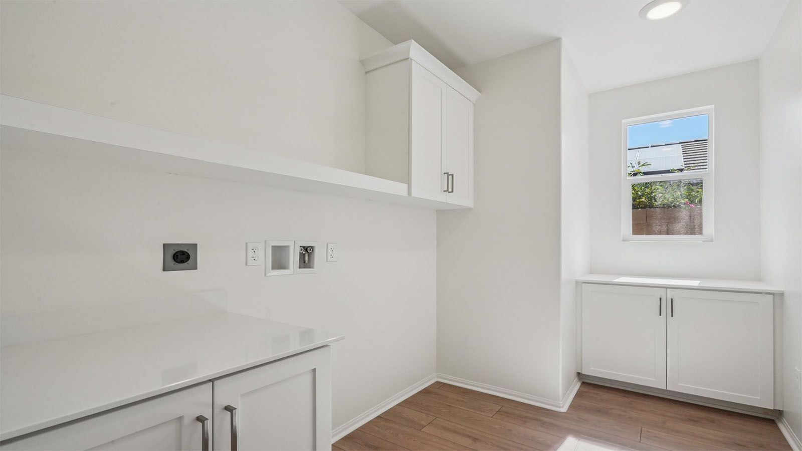 Laundry room with upper and lower cabinets
