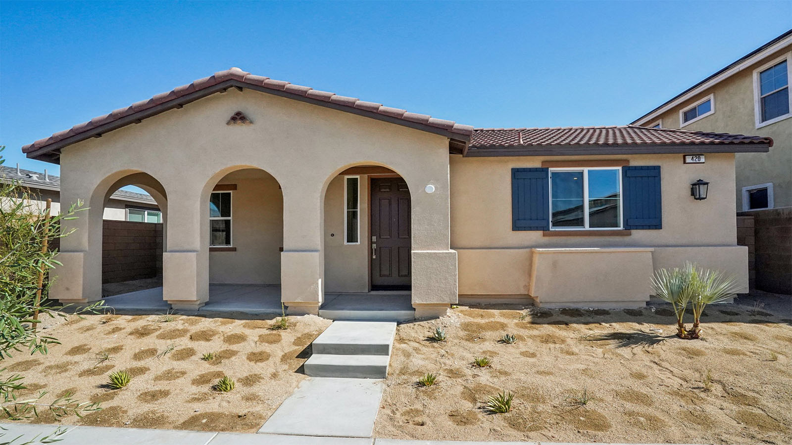 One-story Spanish home with shutters and two-car garage