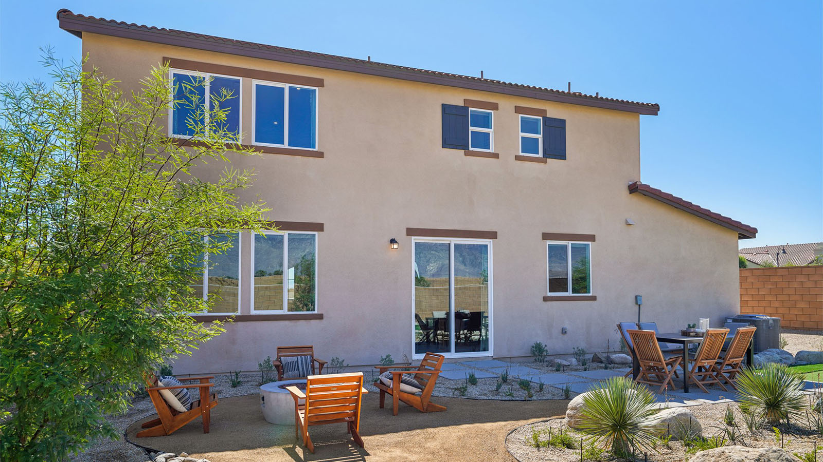 Spacious backyard with turf and seating area
