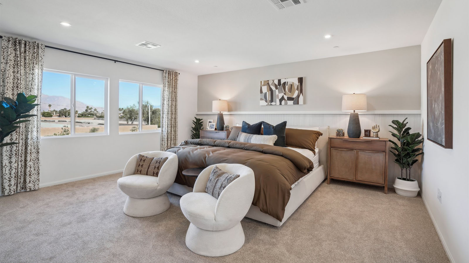 Primary bedroom with king bed and carpet