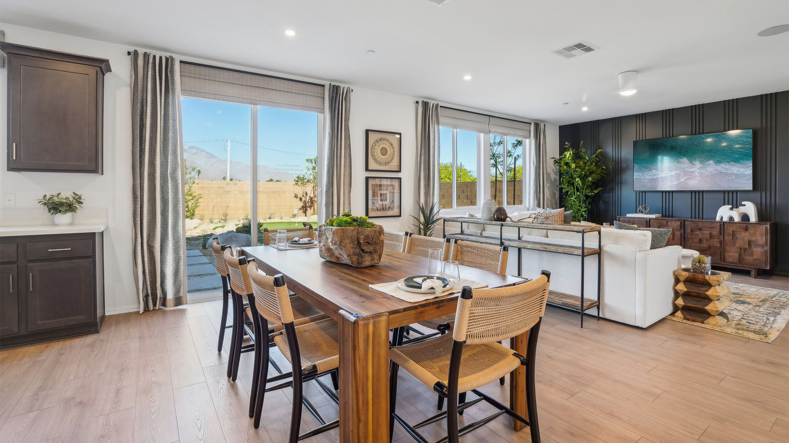 Open kitchen with dark cabinets quartz countertops and stainless steel appliances