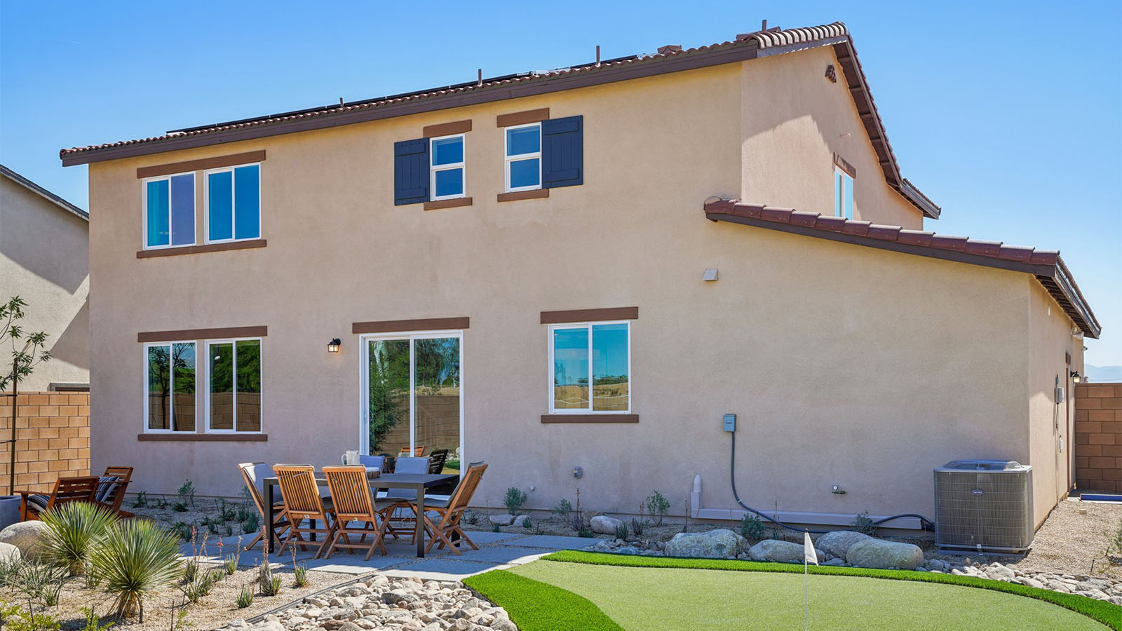 Spacious backyard with turf  and seating area