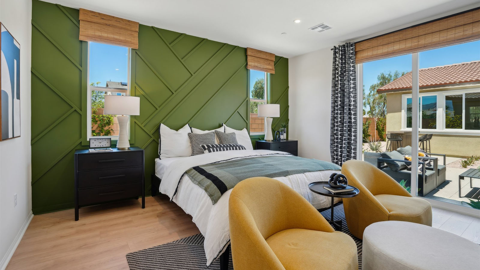 Primary bedroom with king bed and laminate flooring