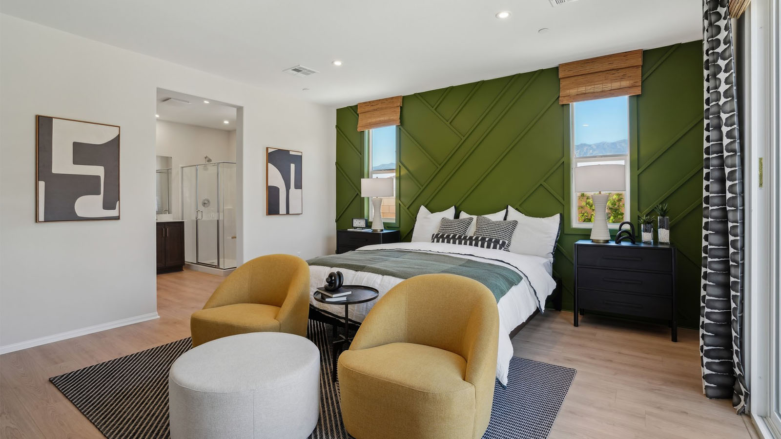 Primary bedroom with king bed and laminate flooring