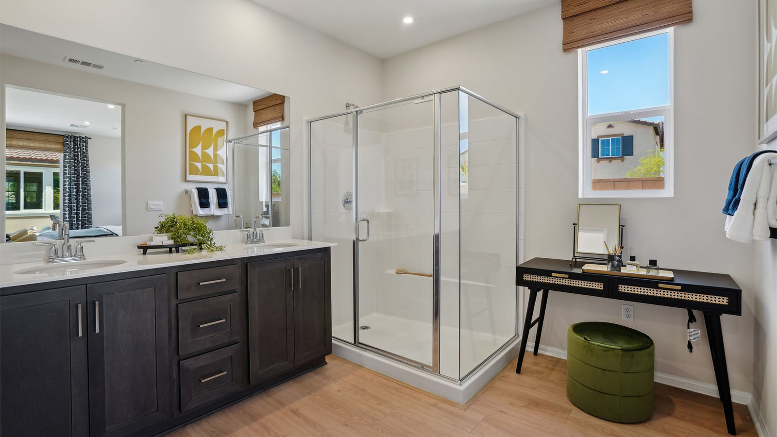Primary bathroom with dual vanities and shower