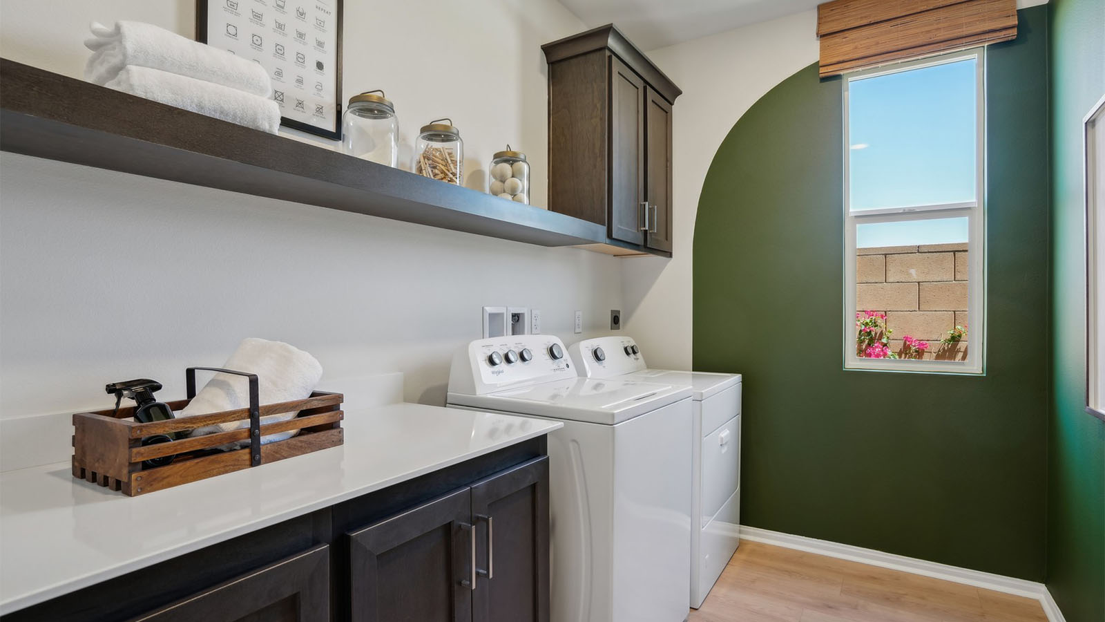 Laundry room with upper cabinet and shelf and washer and dryer