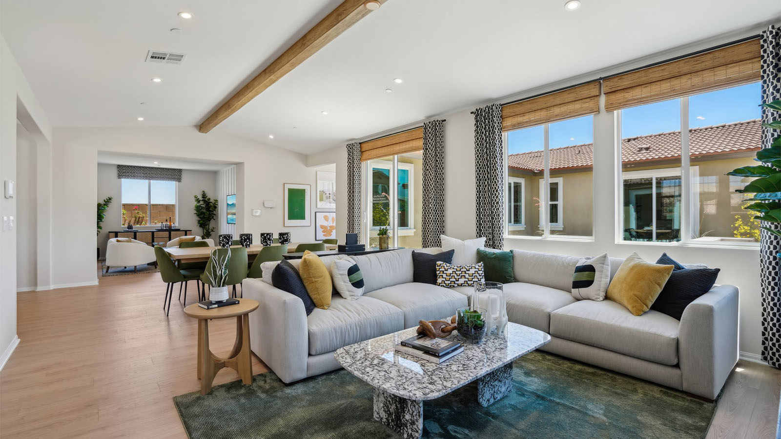 Spacious open-concept great room, dining room and kitchen with vaulted ceiling