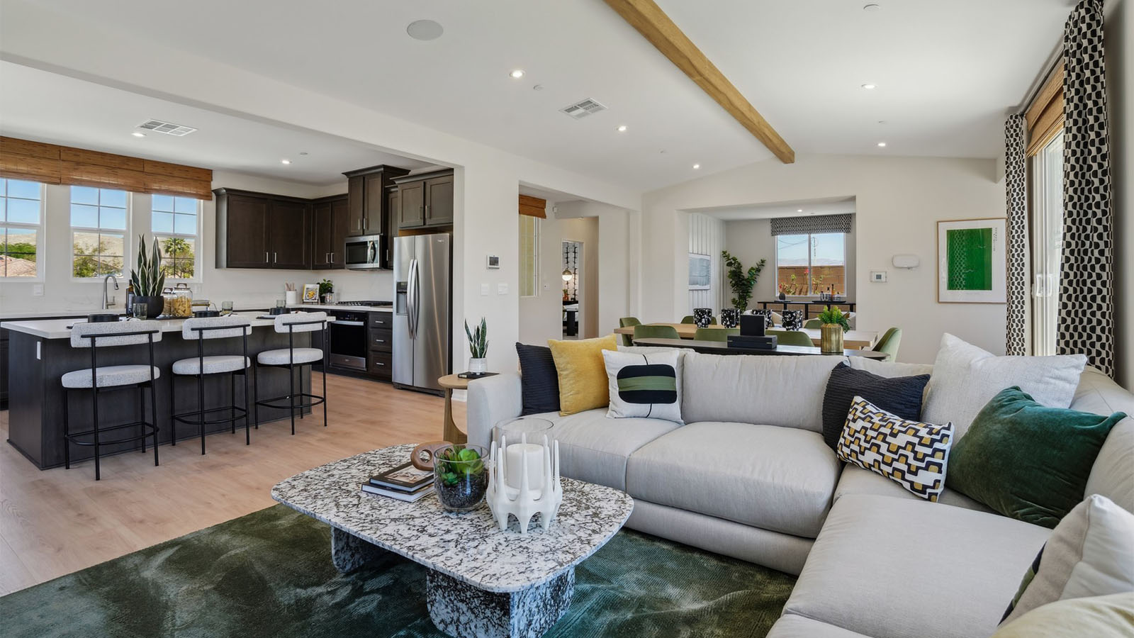 Spacious open-concept great room, dining room and kitchen with vaulted ceiling