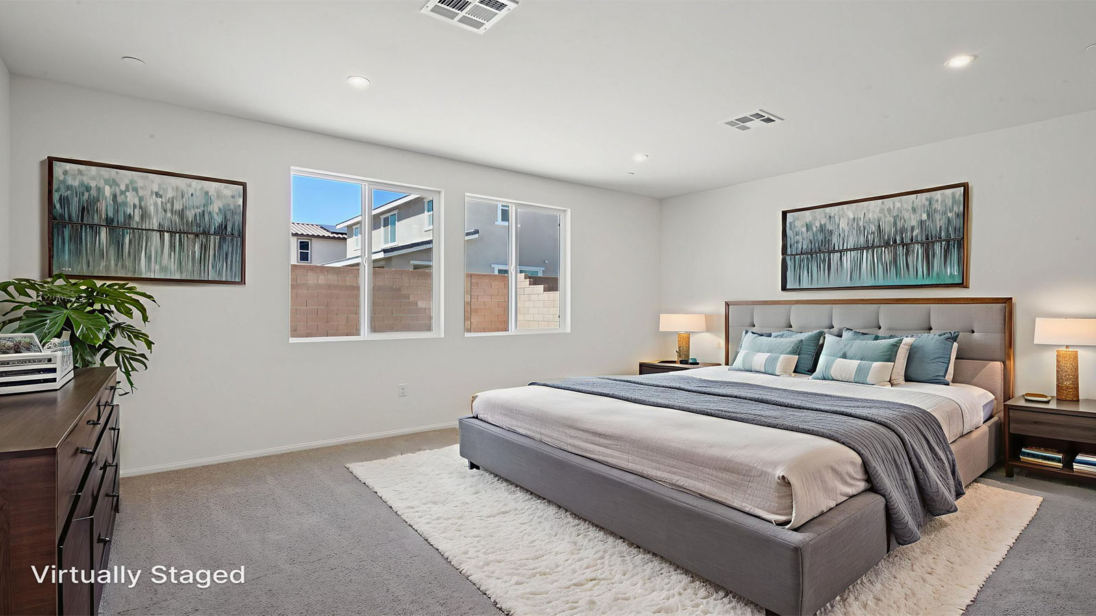 Primary bedroom with king bed and carpet