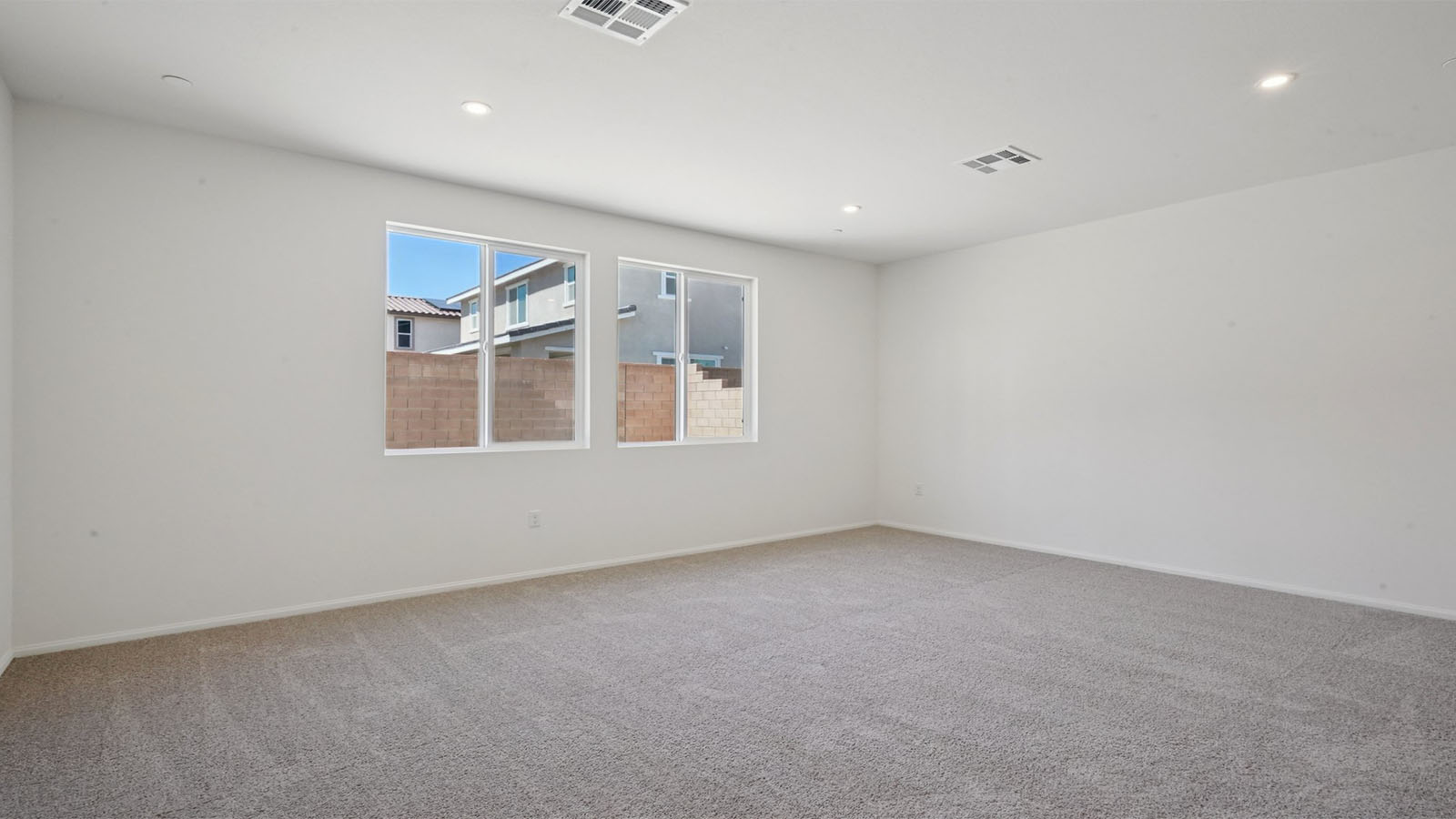 Primary bedroom with king bed and carpet