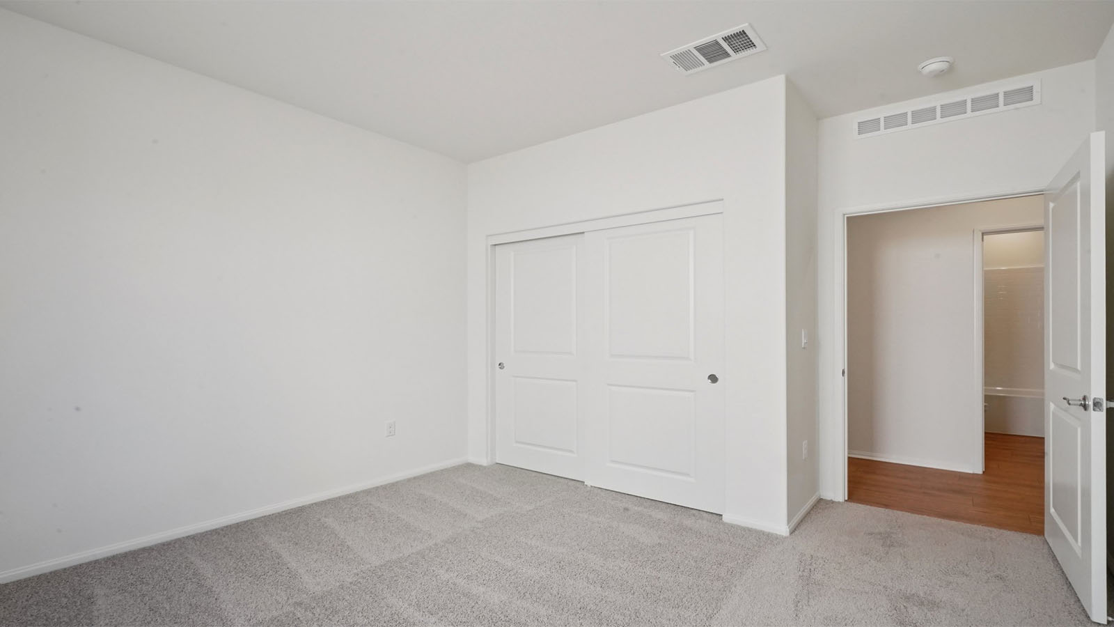 Secondary bedroom with carpet