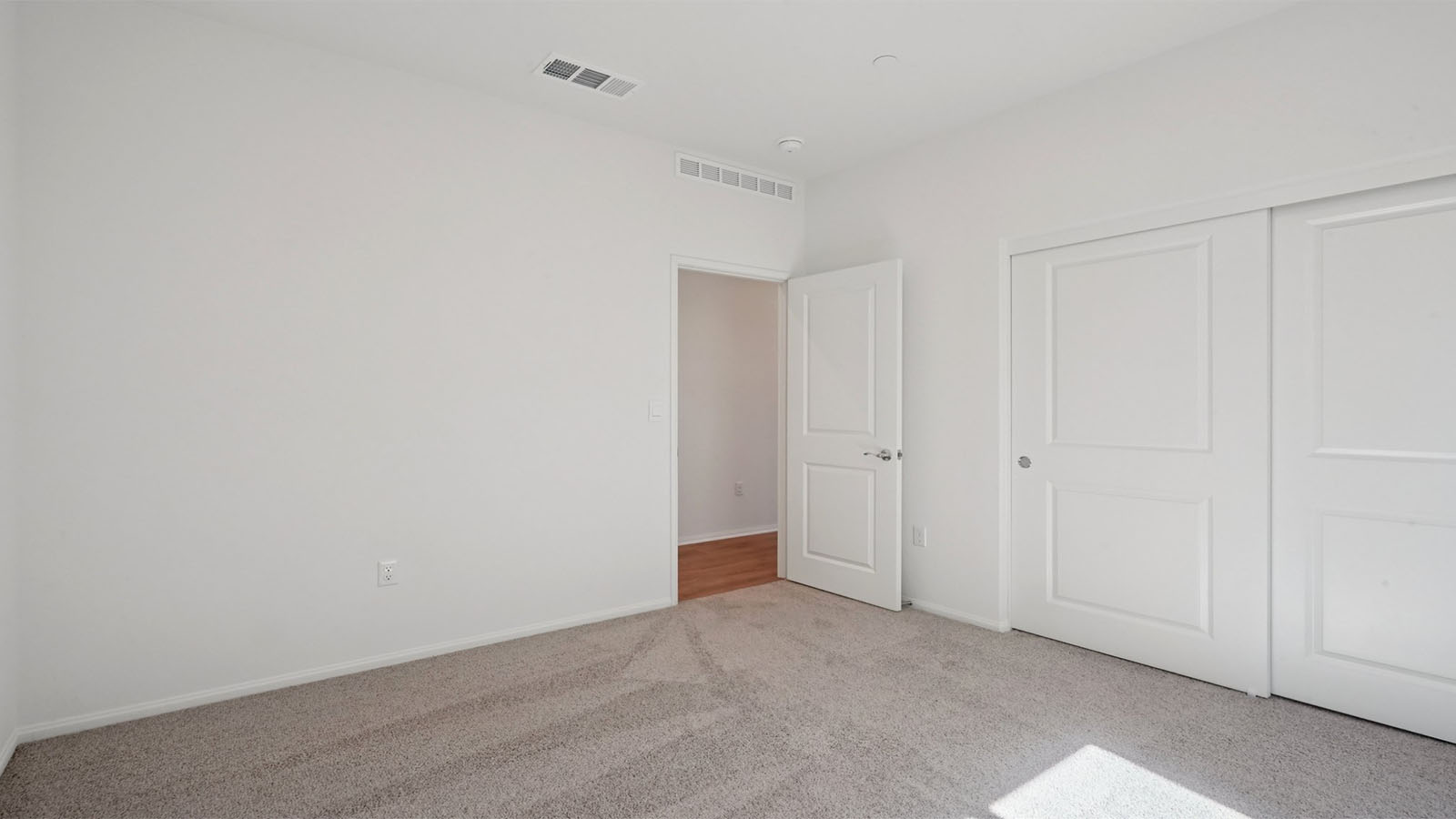 Secondary bedroom with carpet
