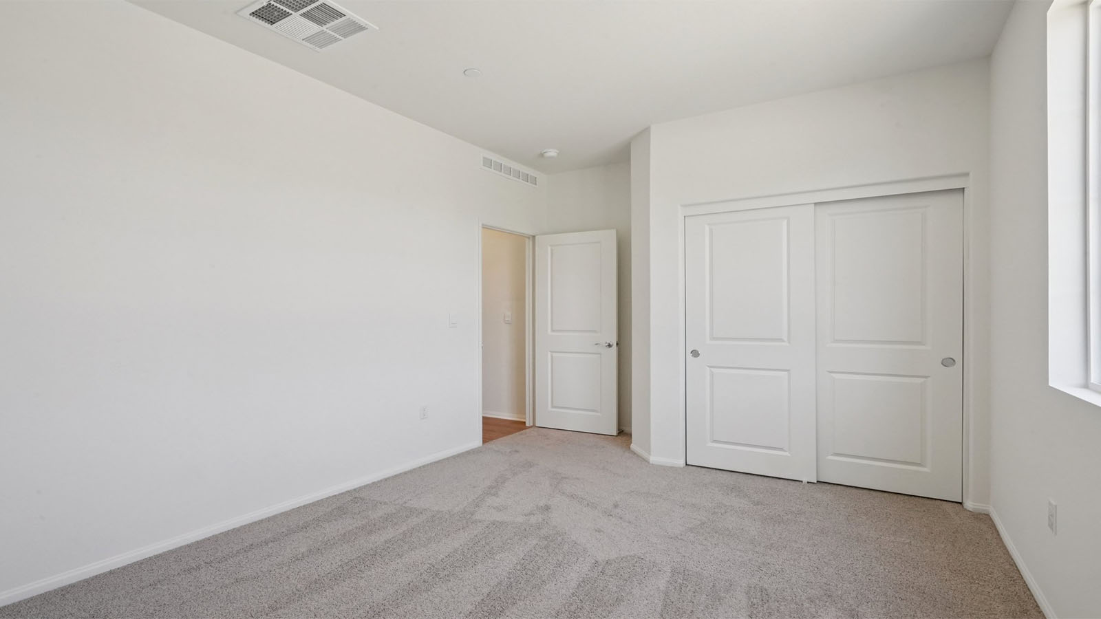 Secondary bedroom with carpet