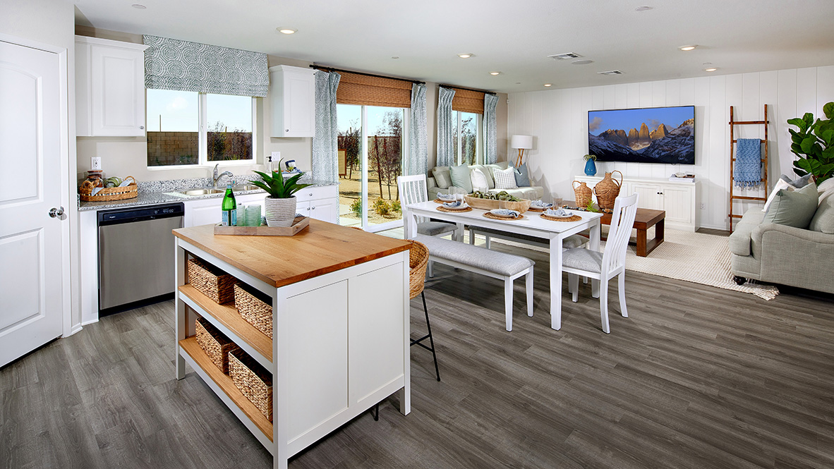 Modern open-concept kitchen with white cabinets and dining room