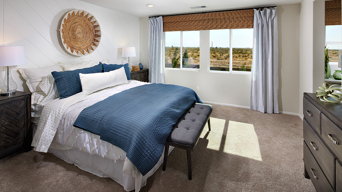 Primary bedroom with plush carpet and king size bed