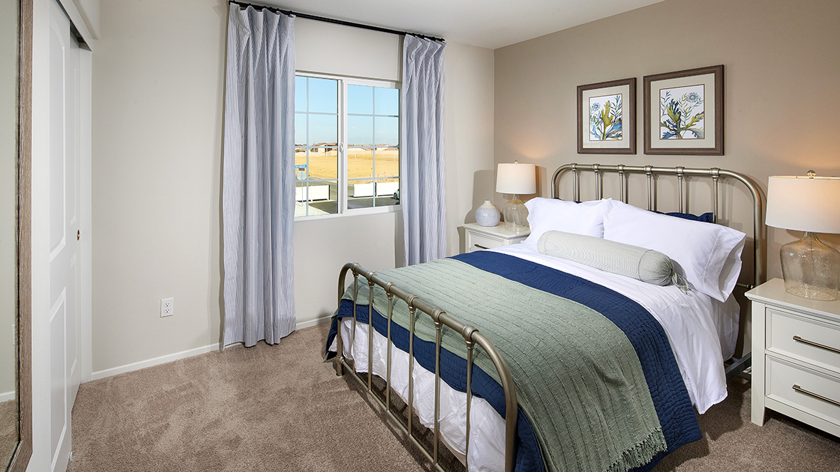 Fully furnished bedroom with plush carpet and full bed