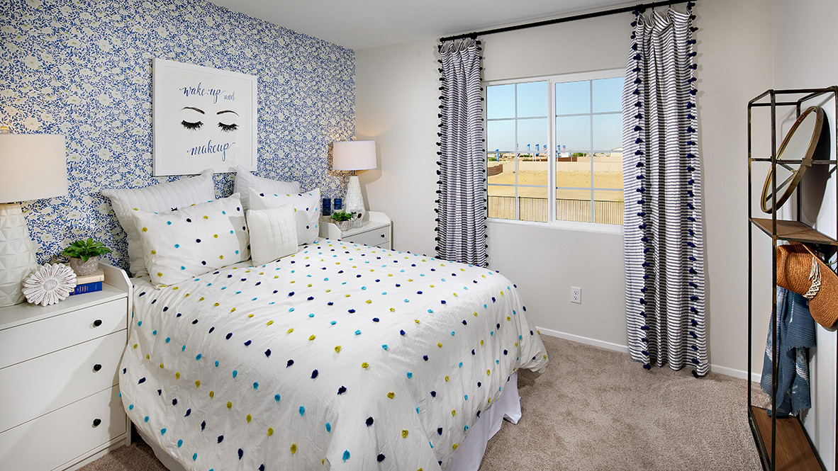 Fully furnished bedroom with plush carpet and full bed