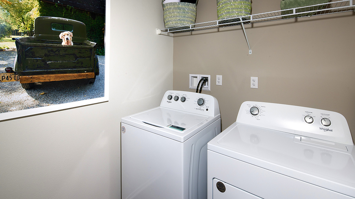 Laundry room with washer and dryer and wire shelving