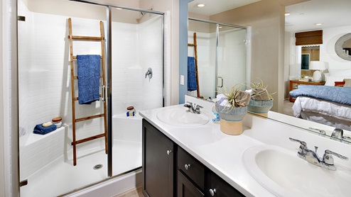 Bathroom with dual vanities and walk in shower