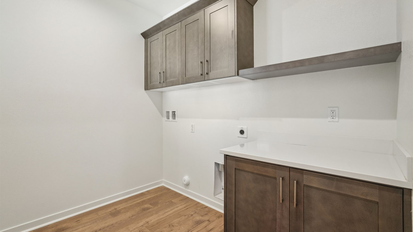Laundry room with upper and lower cabinets