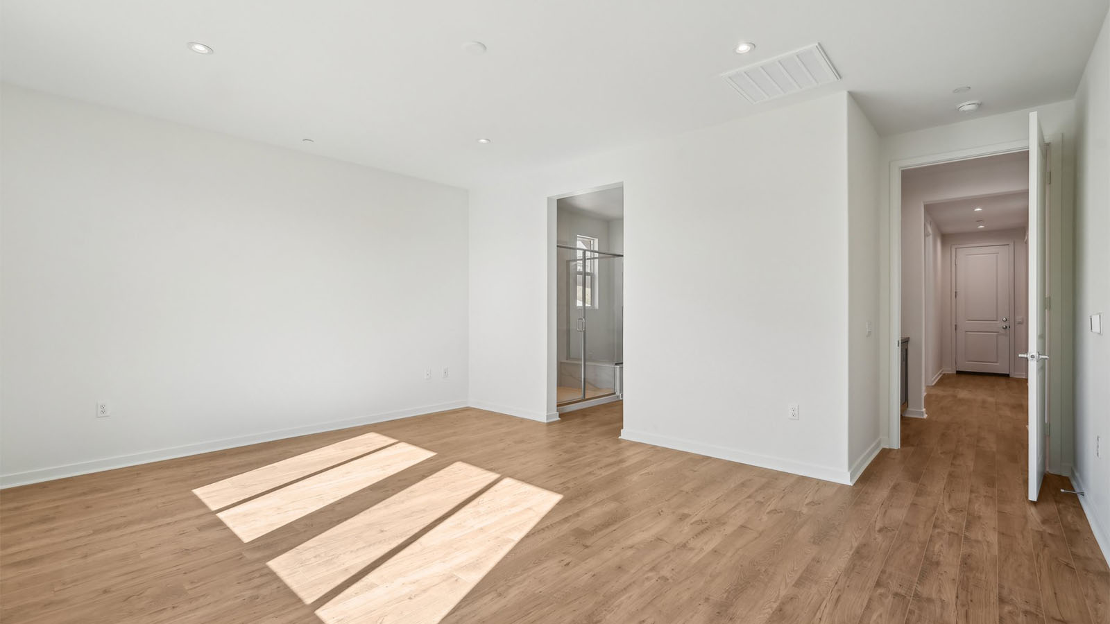 Primary bedroom with laminate flooring