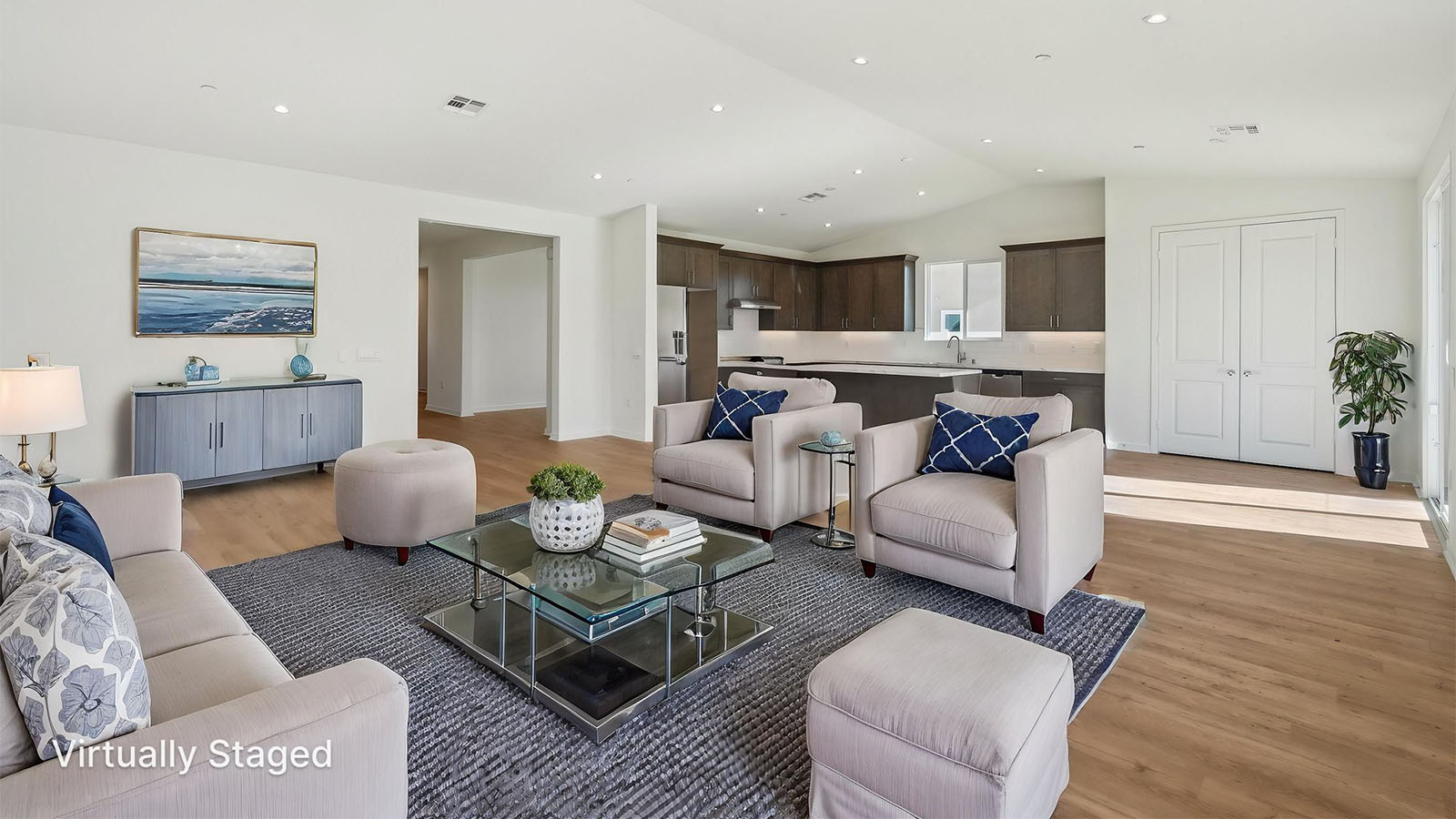 Spacious open-concept great room, dining room and kitchen with vaulted ceiling