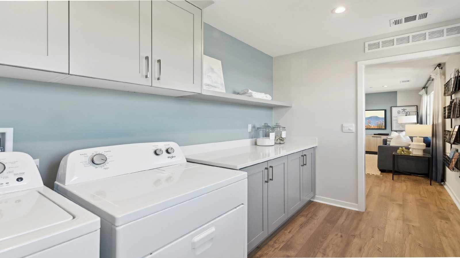 Laundry room with upper cabinets and washer and dryer