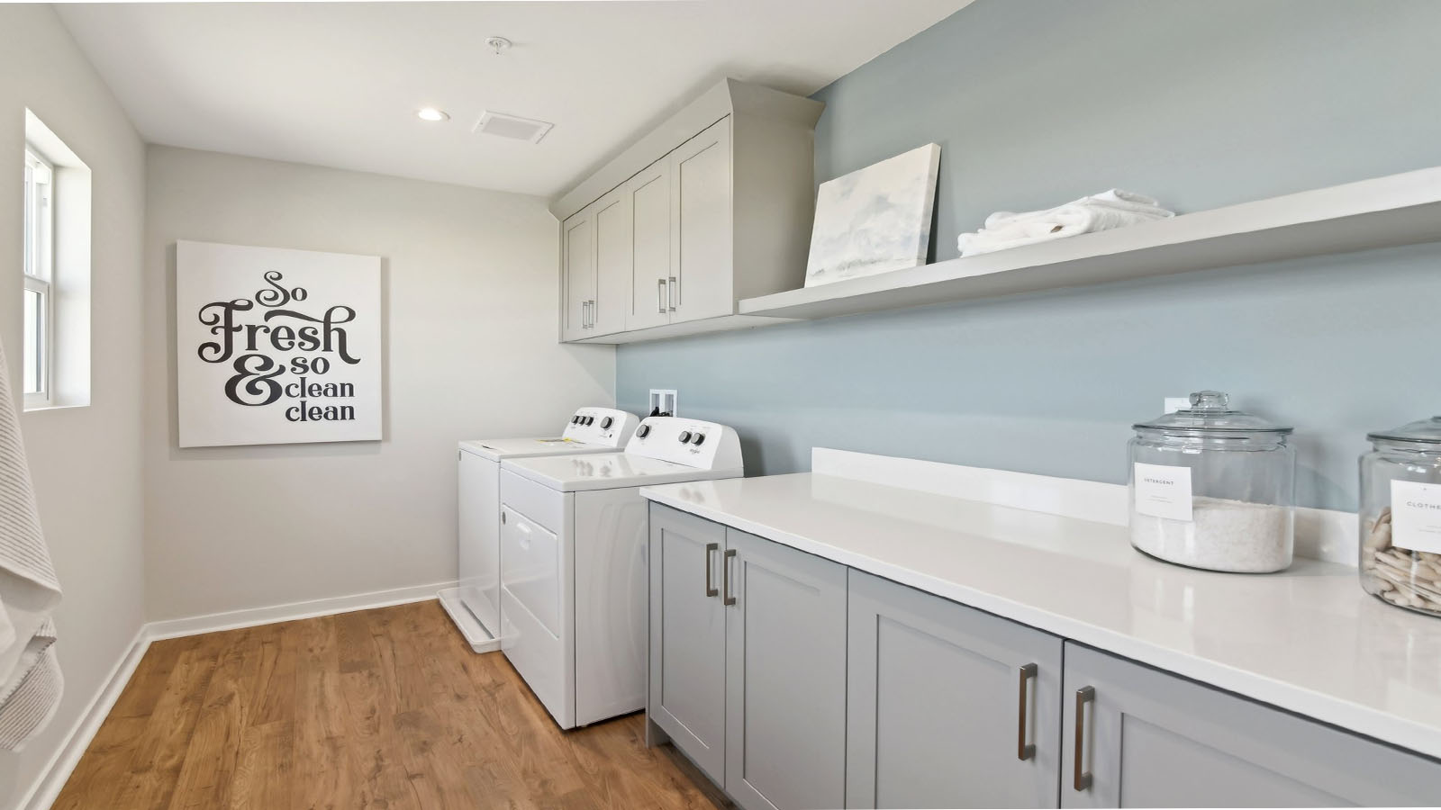 Laundry room with upper cabinets and washer and dryer