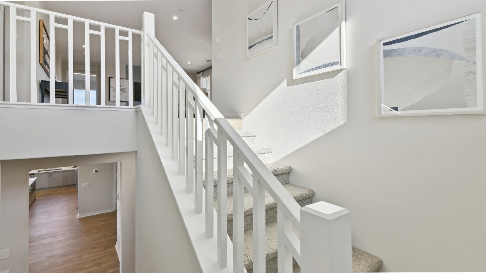 Open railing stairs with white handrail