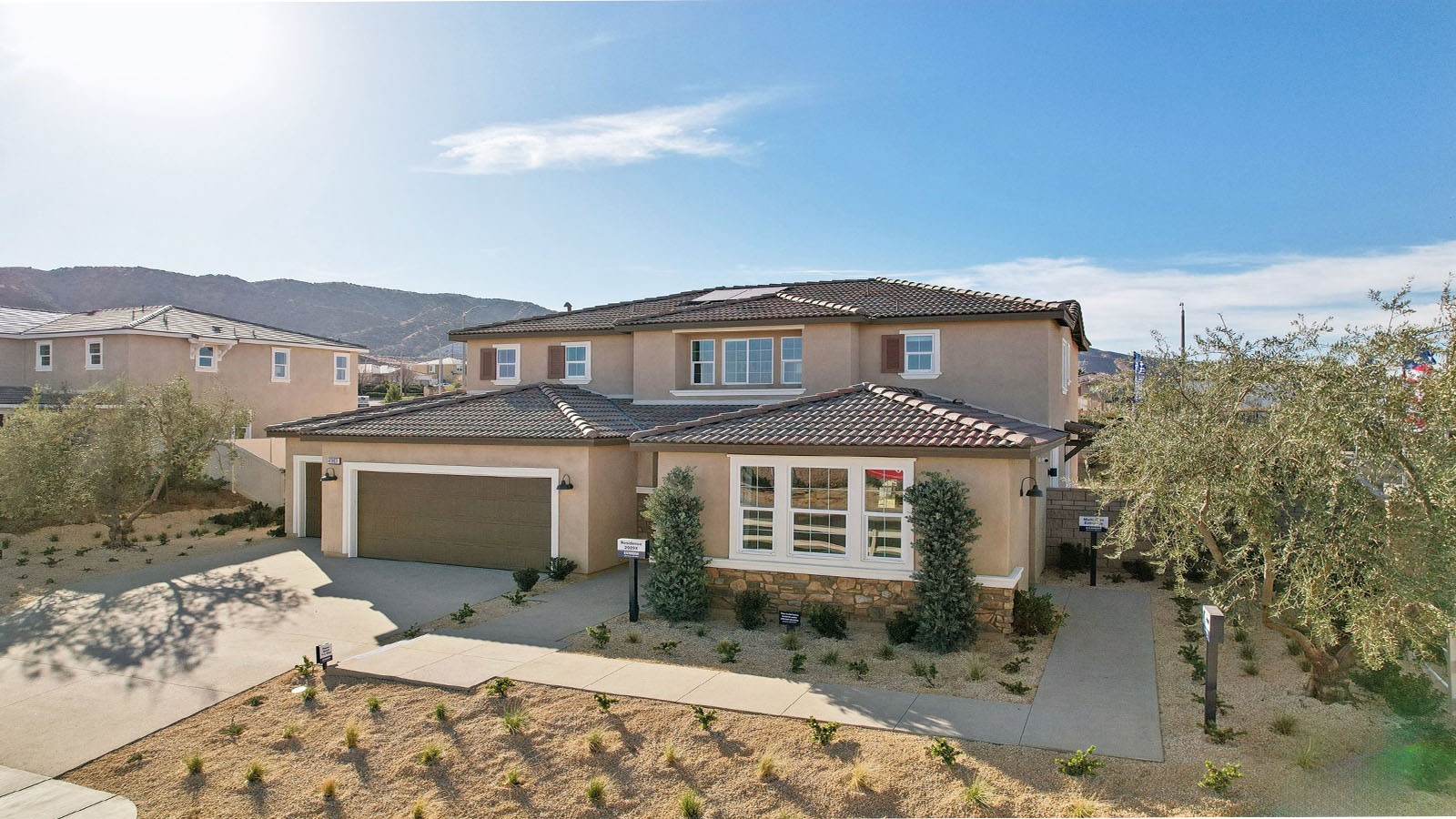 Two-story Tuscan home with stone veneer and three-car garage