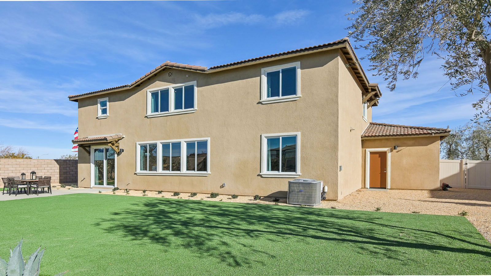 Spacious backyard with turf and patio area