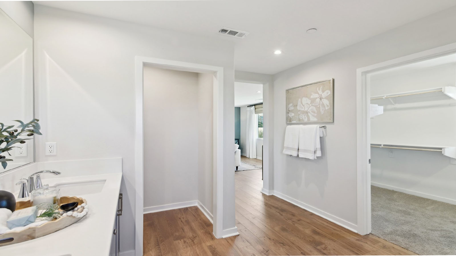 Primary bathroom with dual vanities and walk in shower