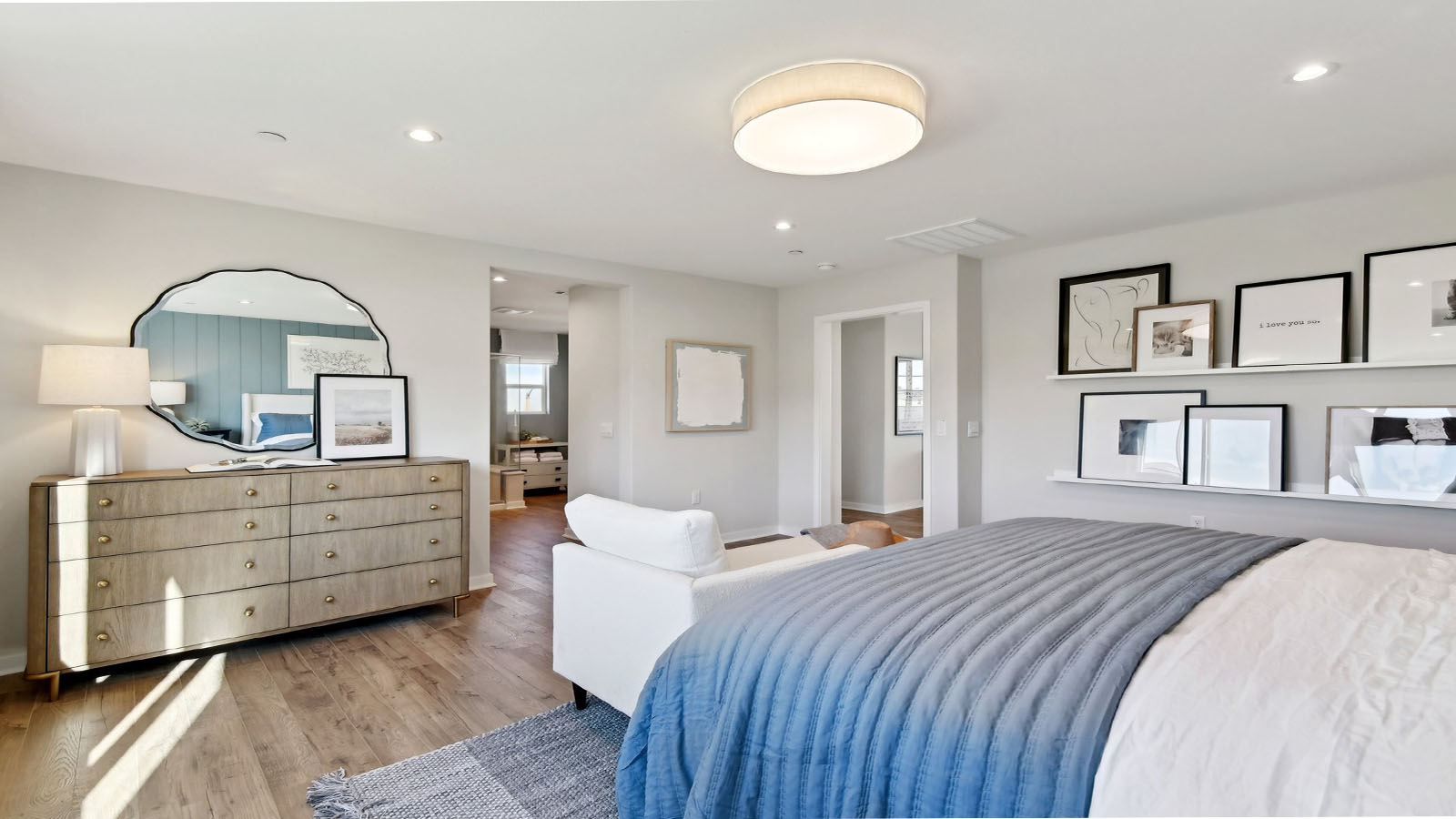 Primary bedroom with king bed and laminate flooring
