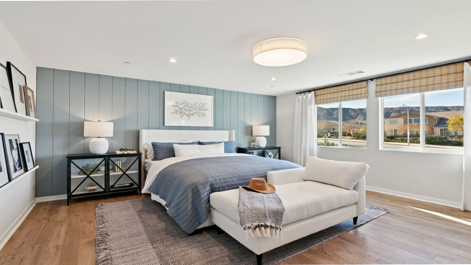 Primary bedroom with king bed and laminate flooring