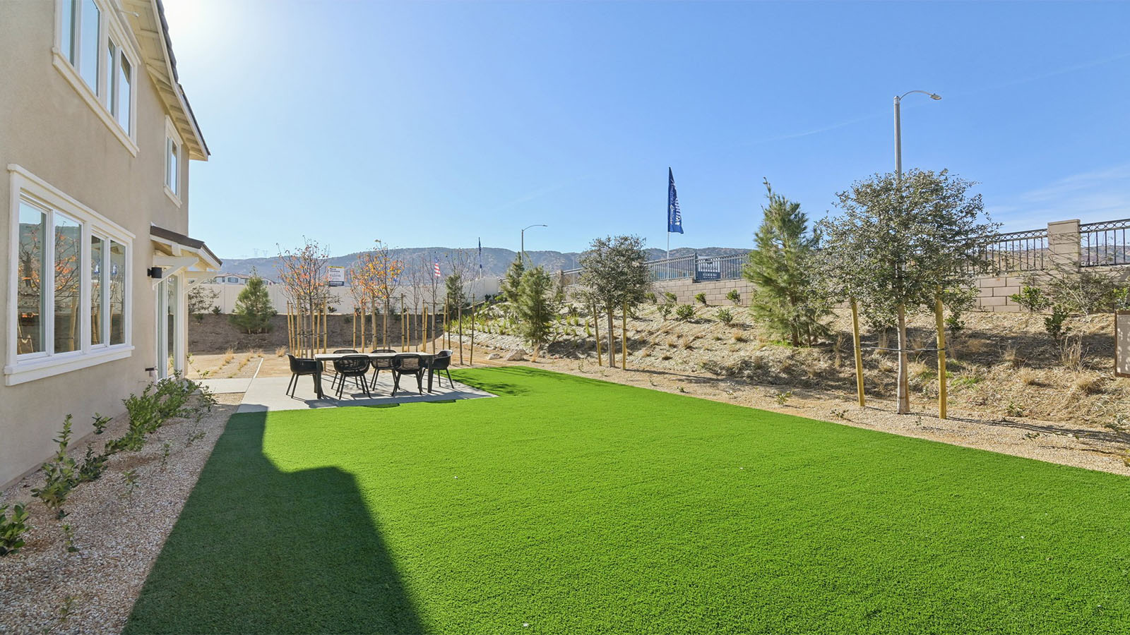 Spacious backyard with turf and patio area