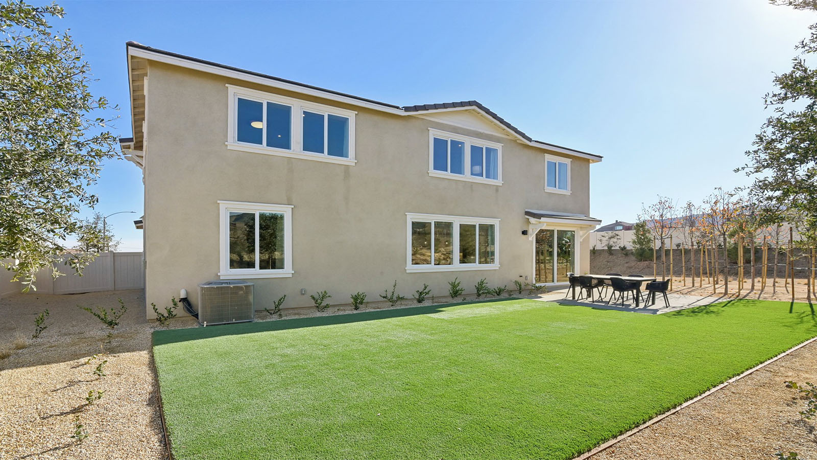 Spacious backyard with turf and patio area