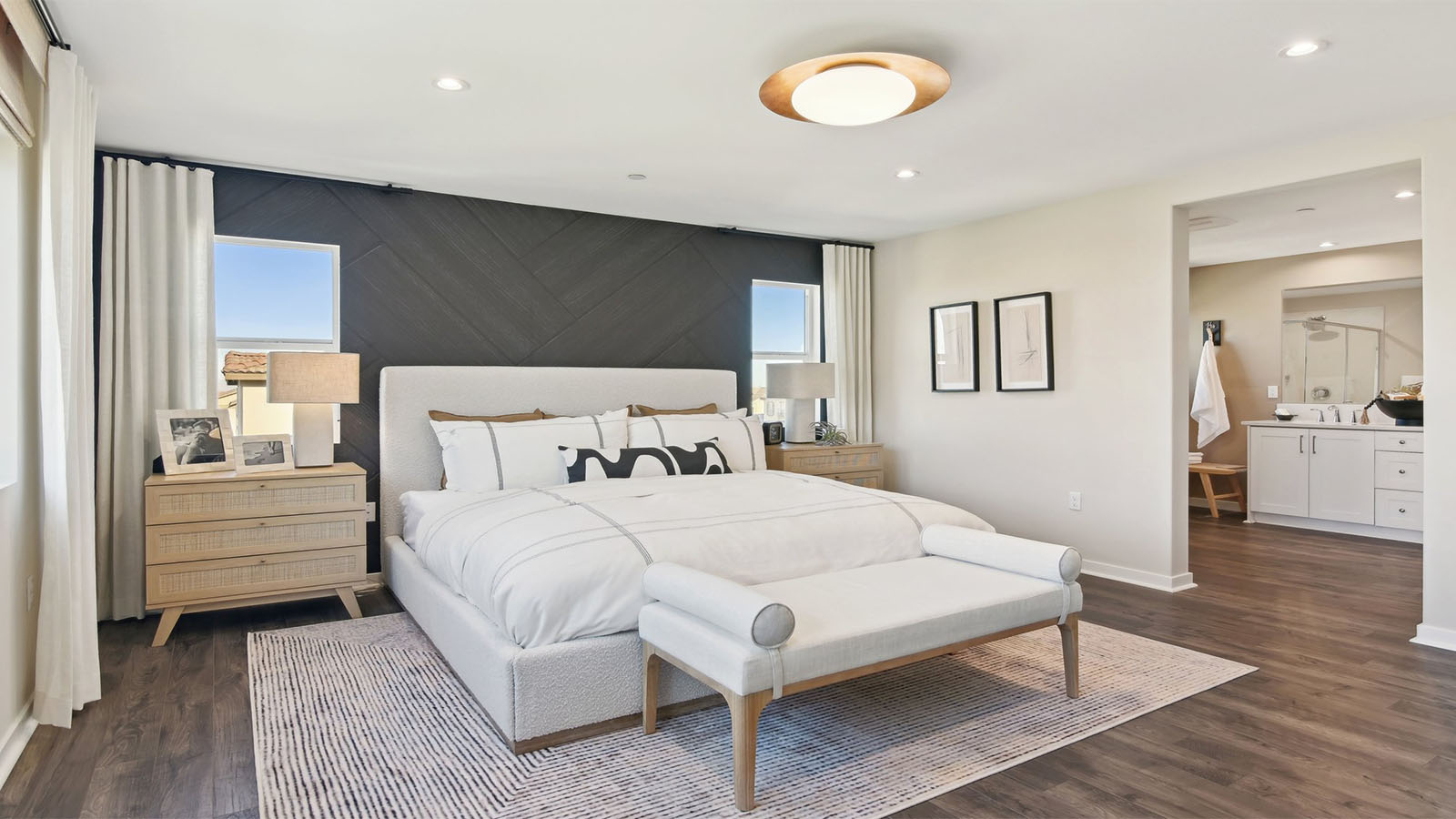 Primary bedroom with king bed and laminate flooring