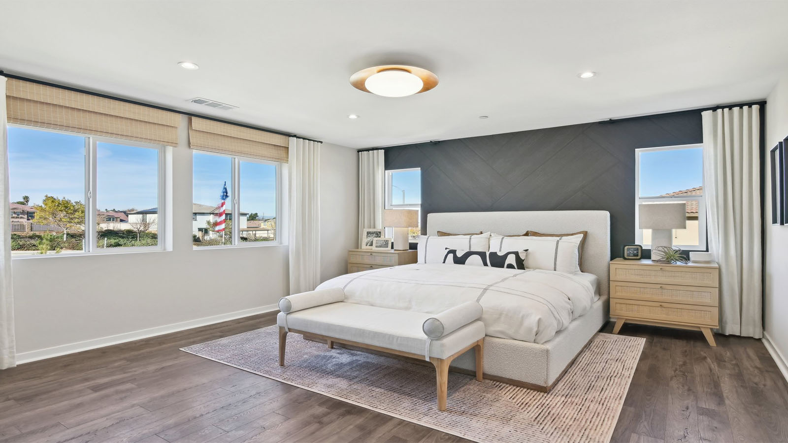 Primary bedroom with king bed and laminate flooring