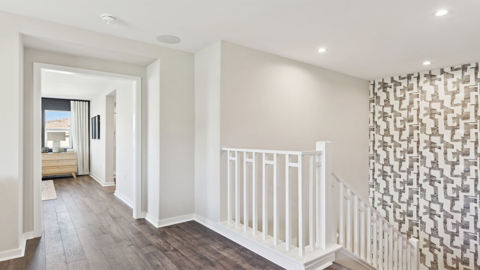 Open railing stairs with white handrail