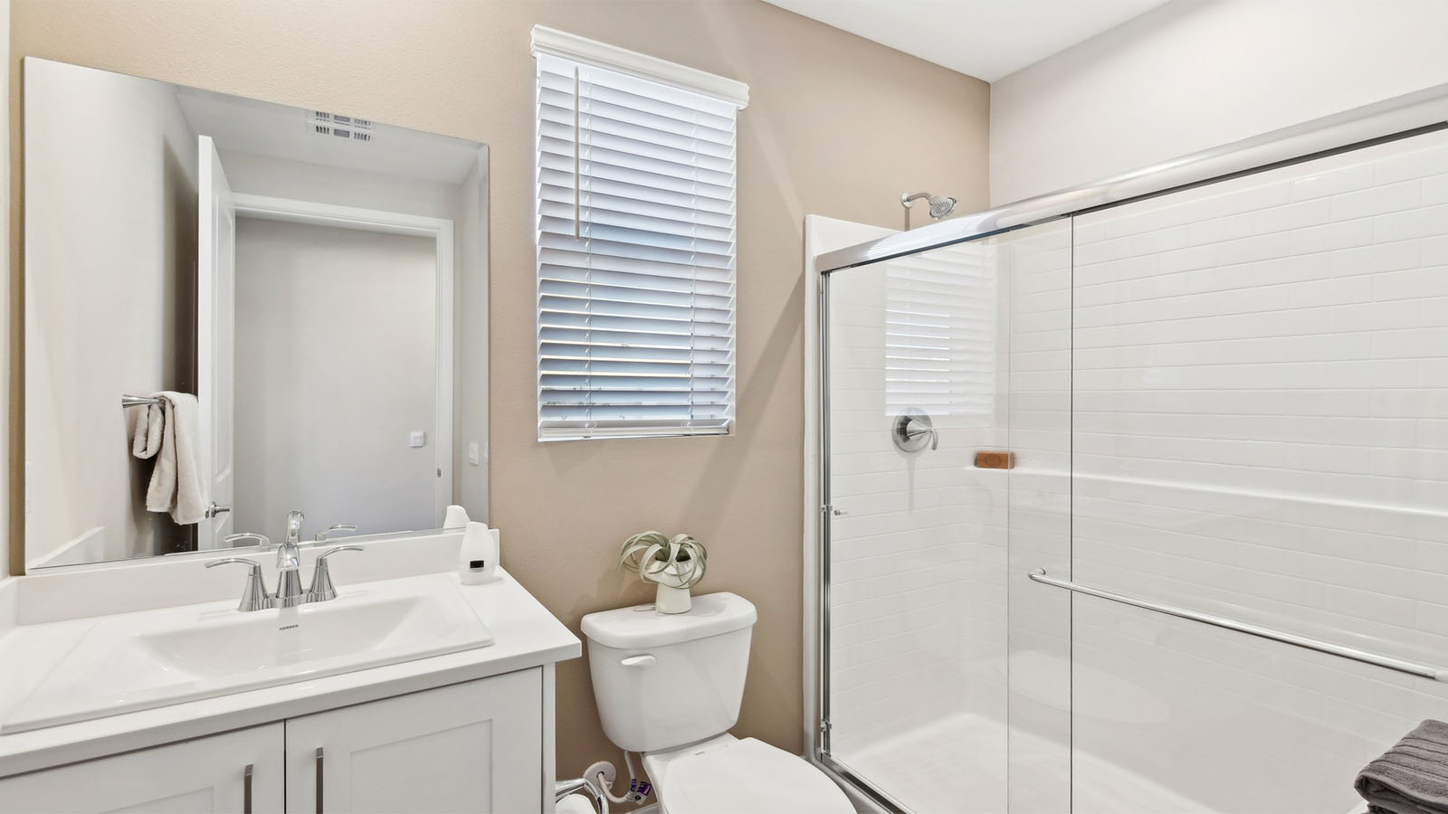 Secondary bathroom with vanity and shower
