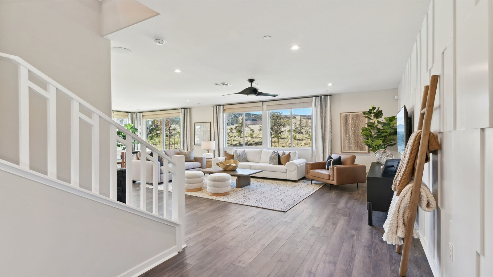 Open railing stairs with white handrail