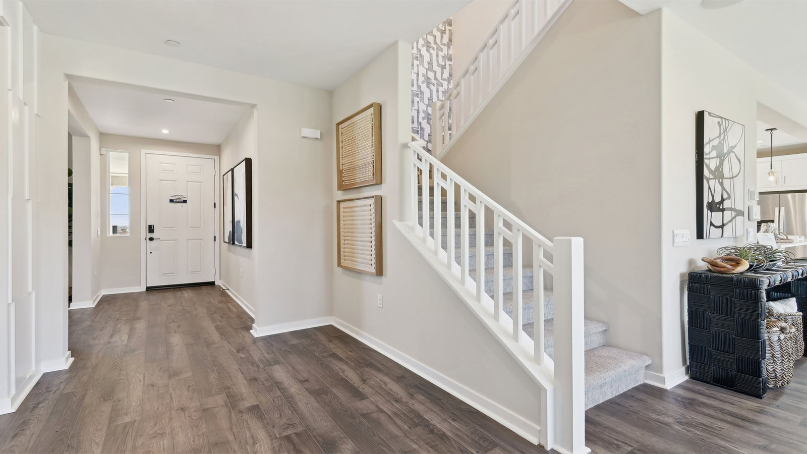 Open railing stairs with white handrail